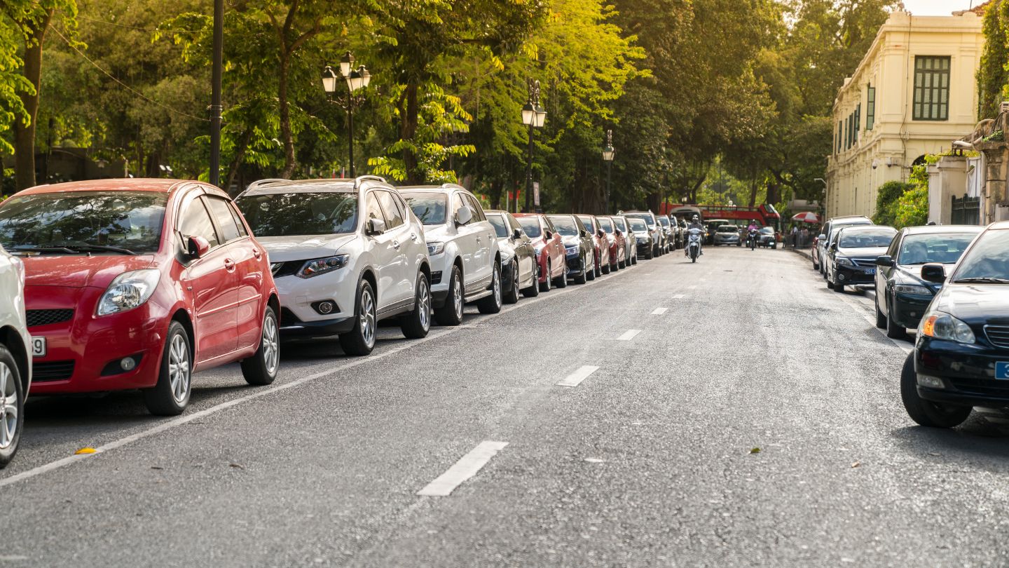 Street View Of Parked Vehicles Under Trees