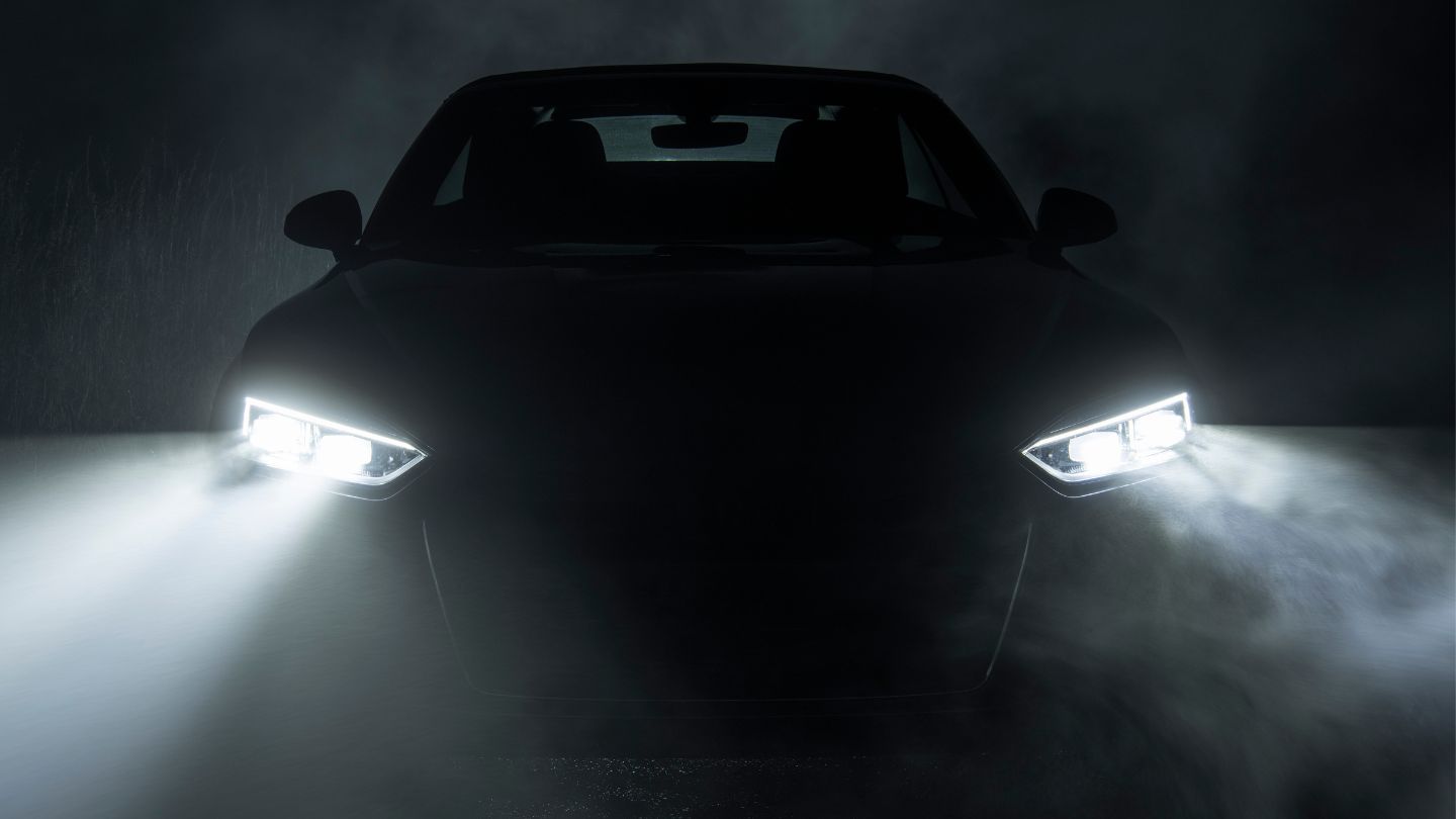 Car With Headlights On In The Dark