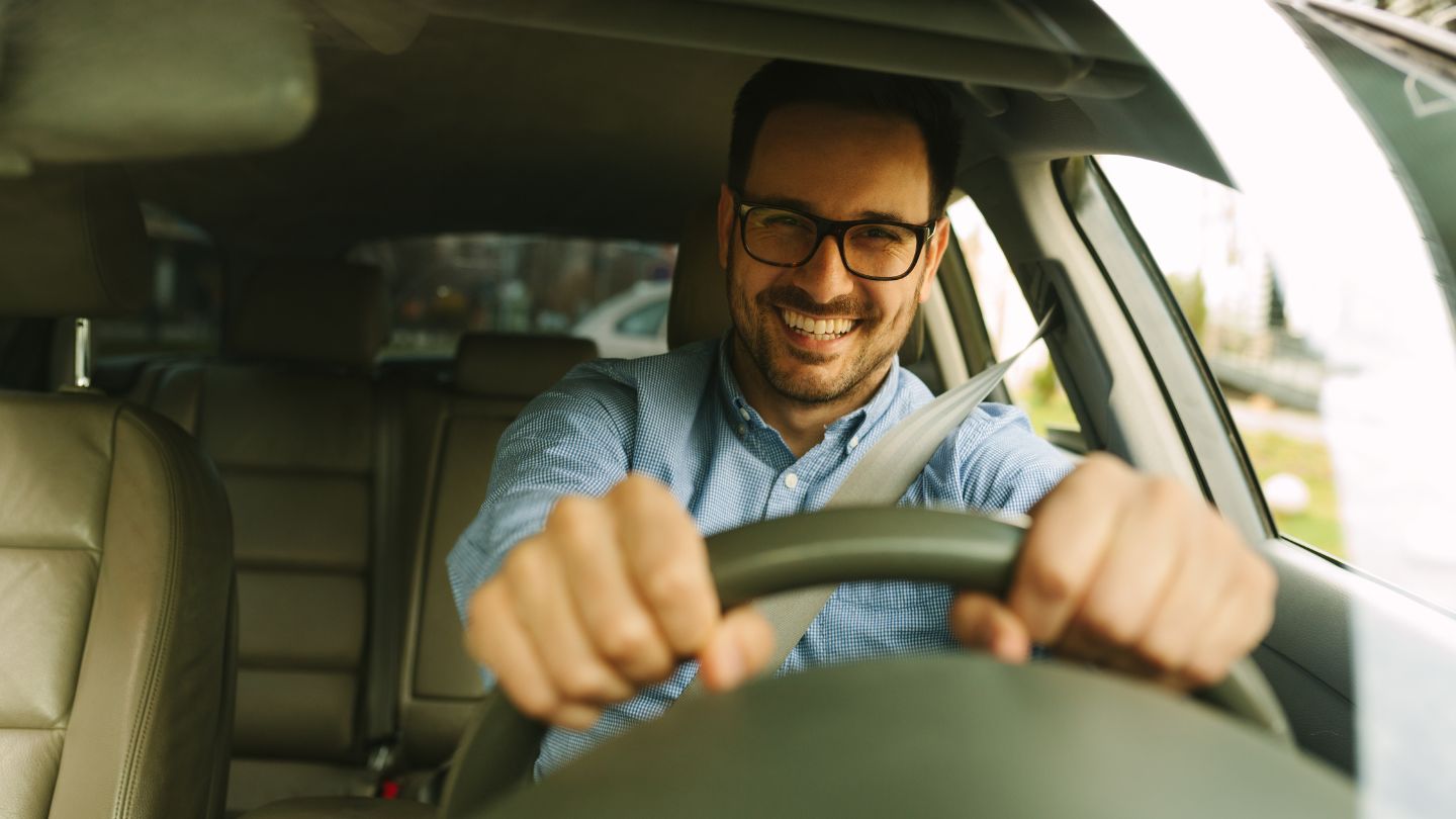 Man Confidently Driving A Car