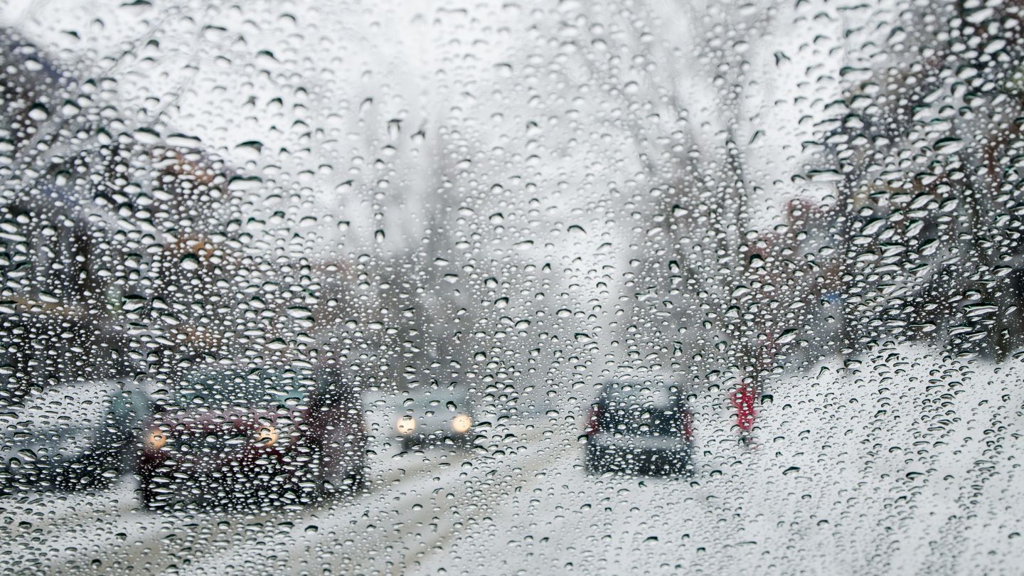 Snow Covered Windshield With Blurry Road View