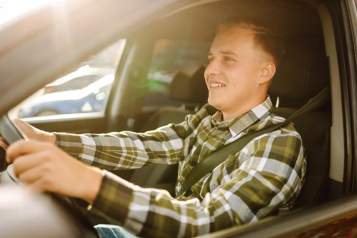 smiling man driving car
